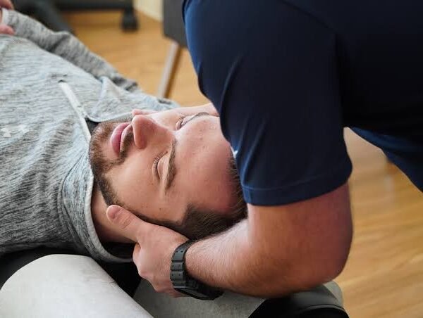 Chiropractor supporting a patient's head during a neck adjustment
