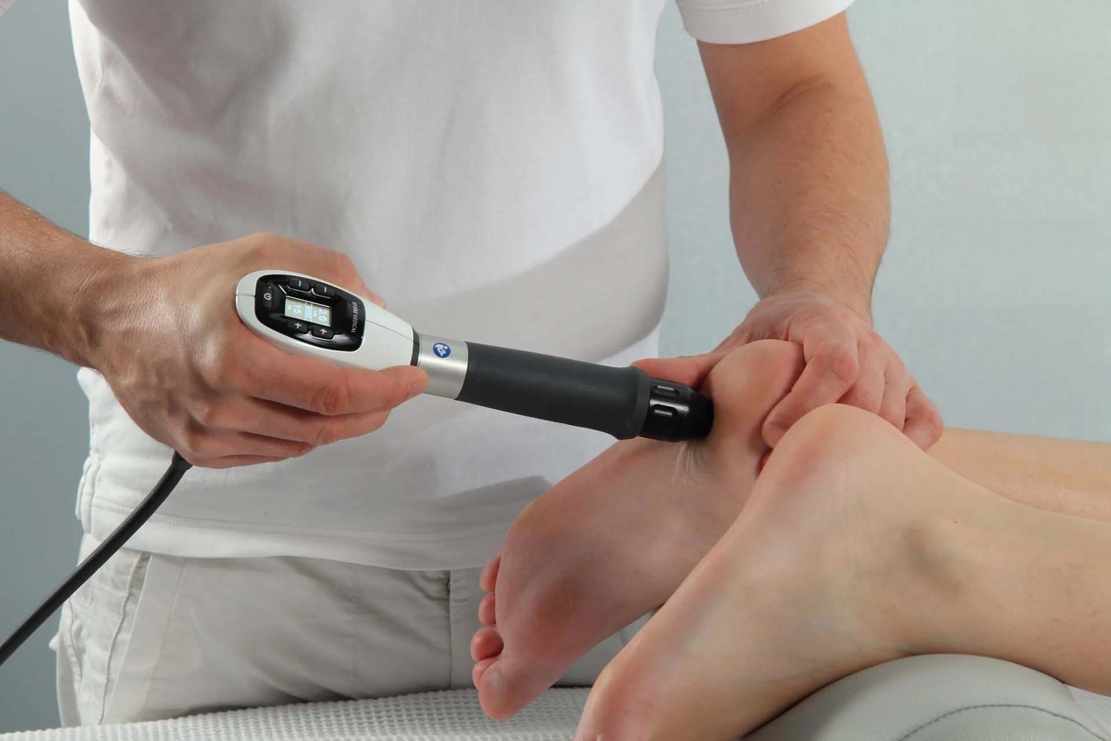 Shockwave therapy device applied to a patient's heel